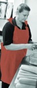 17 Micron Orange Disposable Aprons on a roll - 116cm Long